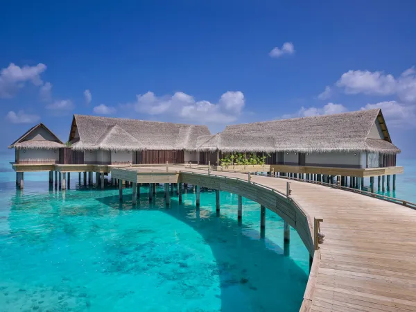 Spacious three‑bedroom over‑water villa with two infinity pools and ocean-view jetty at JOALI Maldives.