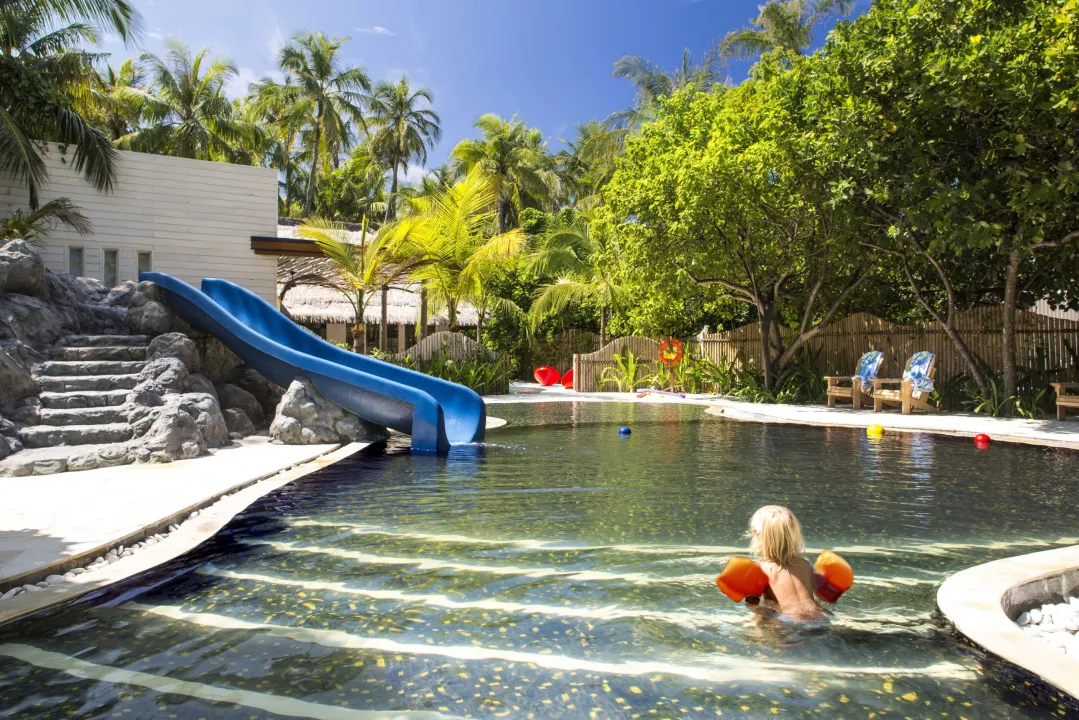 Kid-friendly pool with water slide at Cheval Blanc Randheli