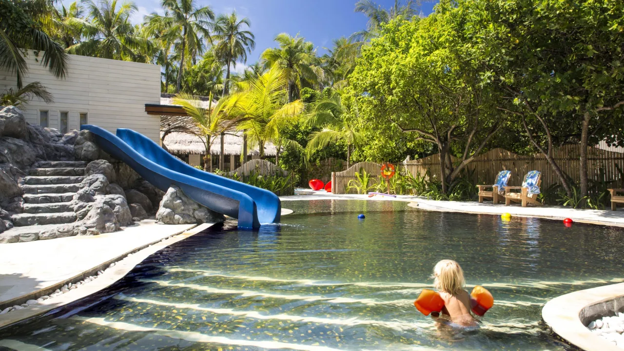 Kid-friendly pool with water slide at Cheval Blanc Randheli