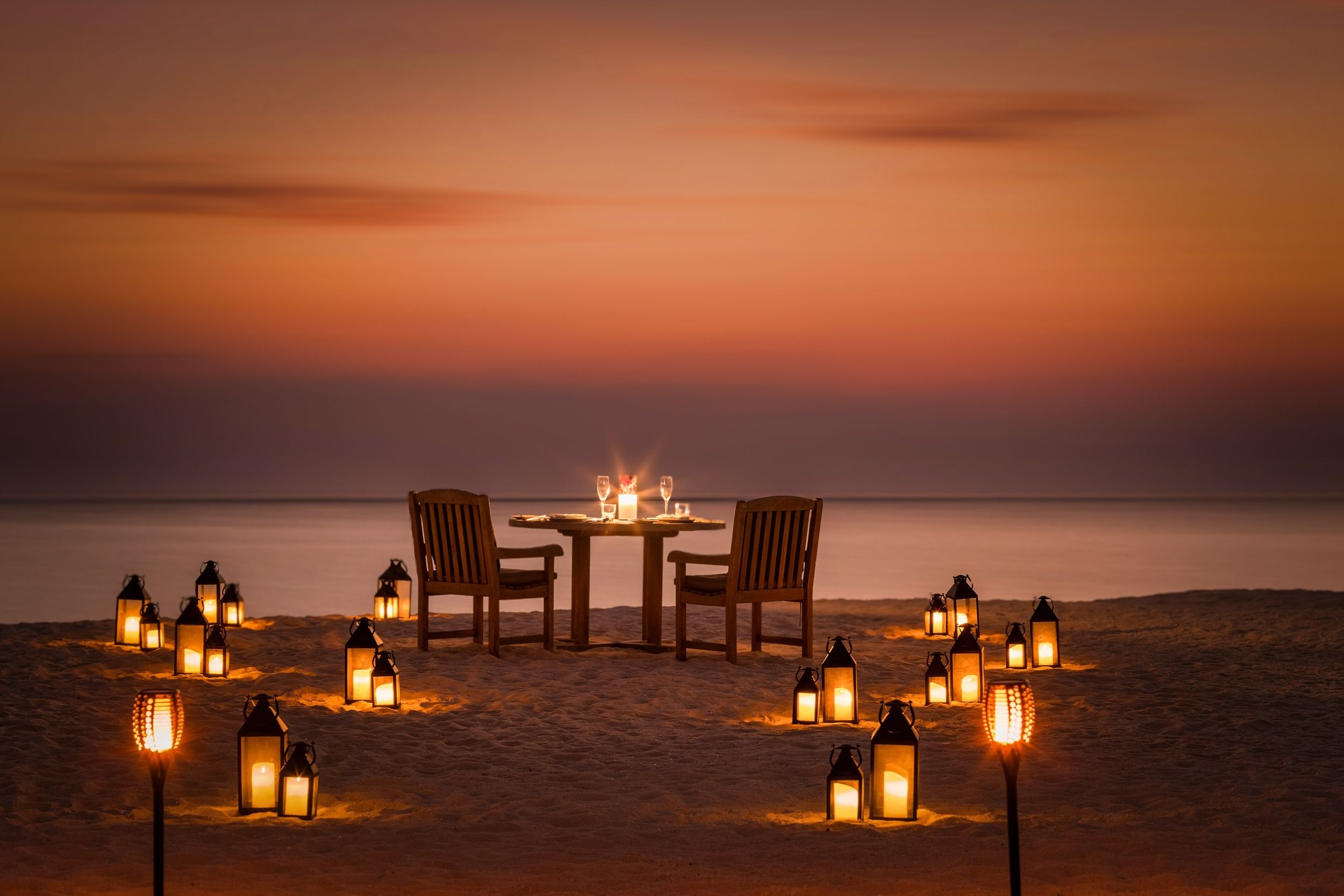 Beachside table setup ready for a dinner under the open sk