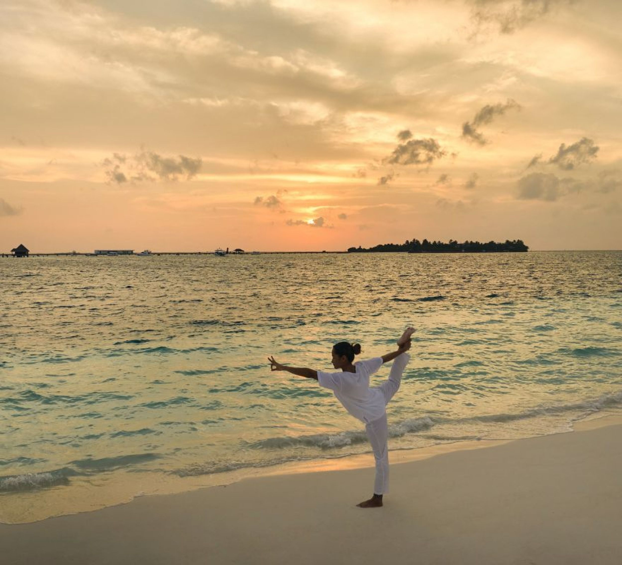 Yoga on the beach at sunrise