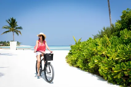 A woman cycles around the resort.