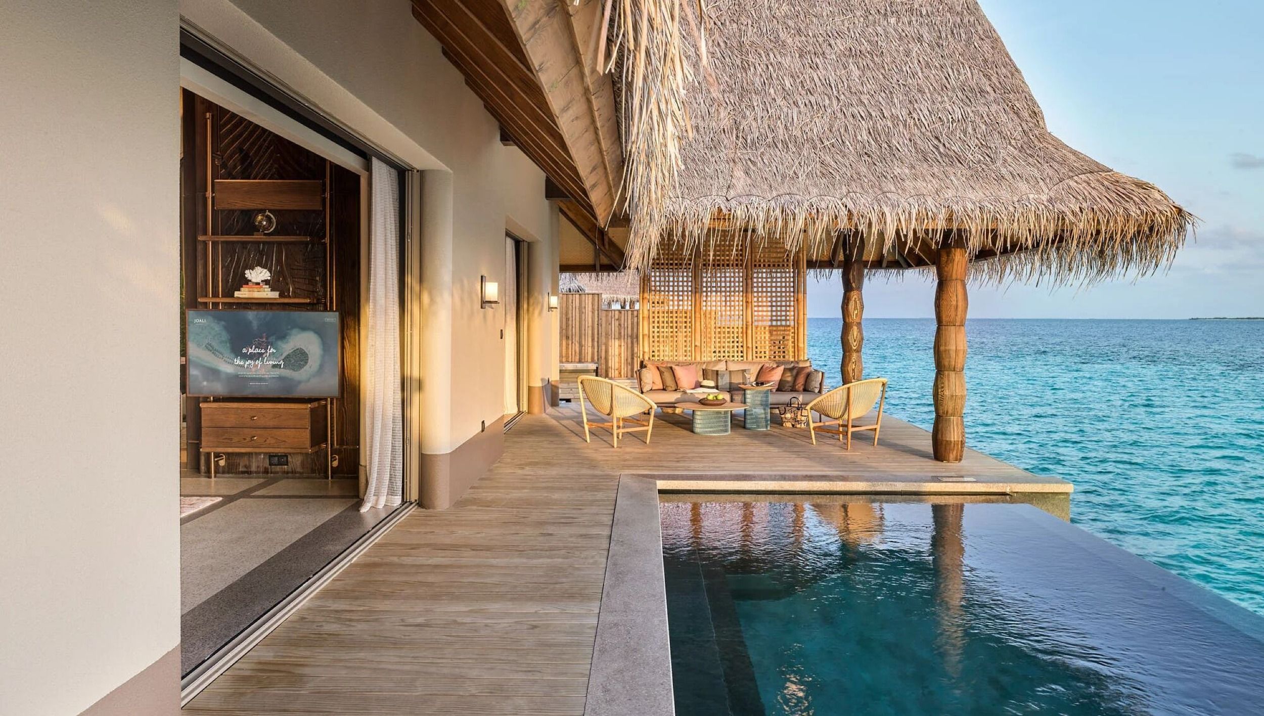Private infinity pool with spacious wooden deck overlooking the ocean