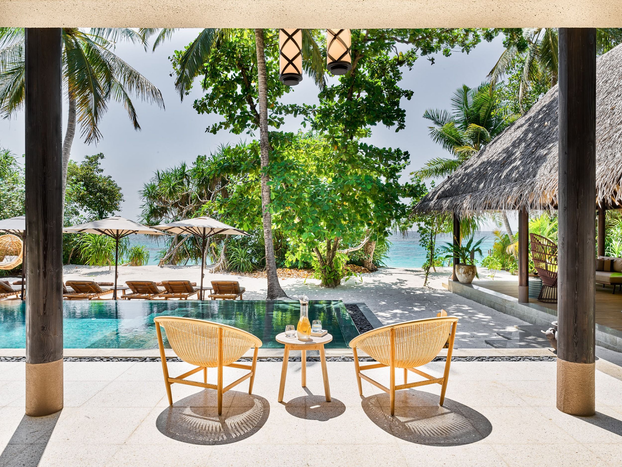 Sun dappled outdoors with pool and loungers