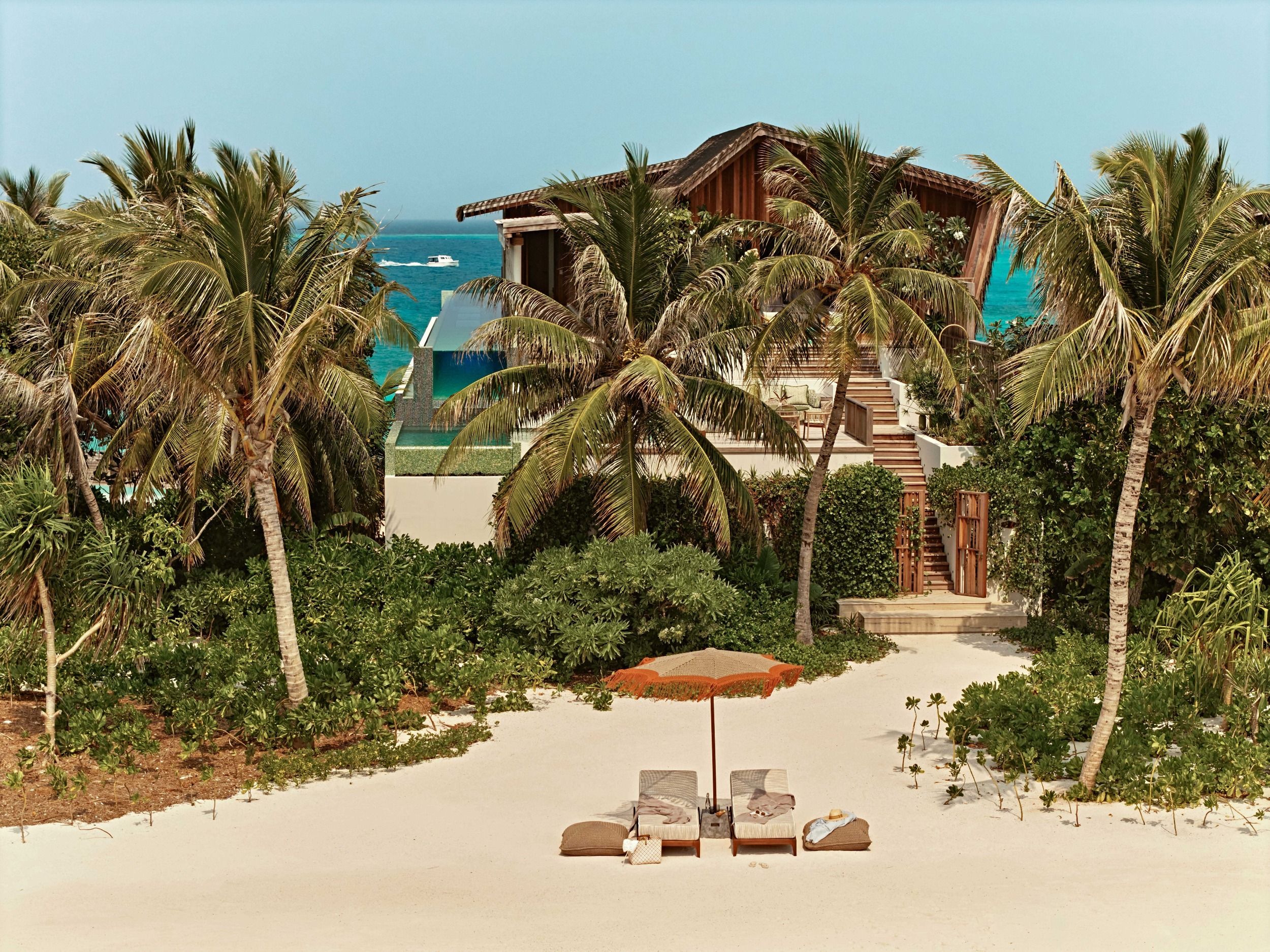 Aerial beach front view of a four-bedroom residence