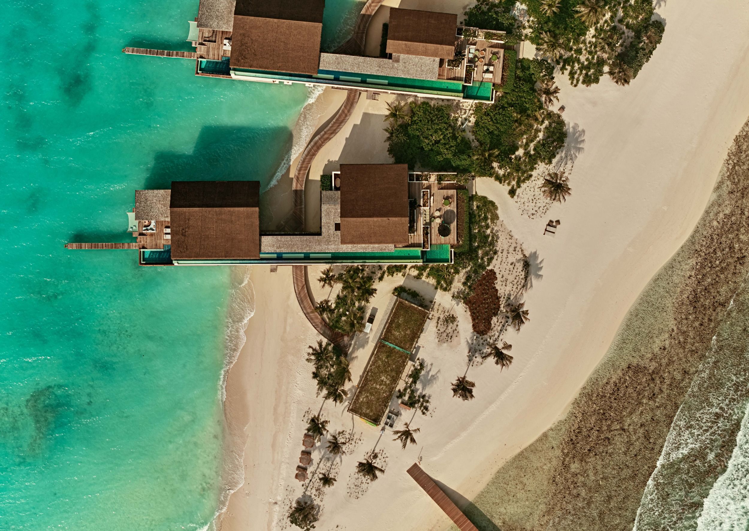 Aerial beachside view of three- and four-bedroom residences