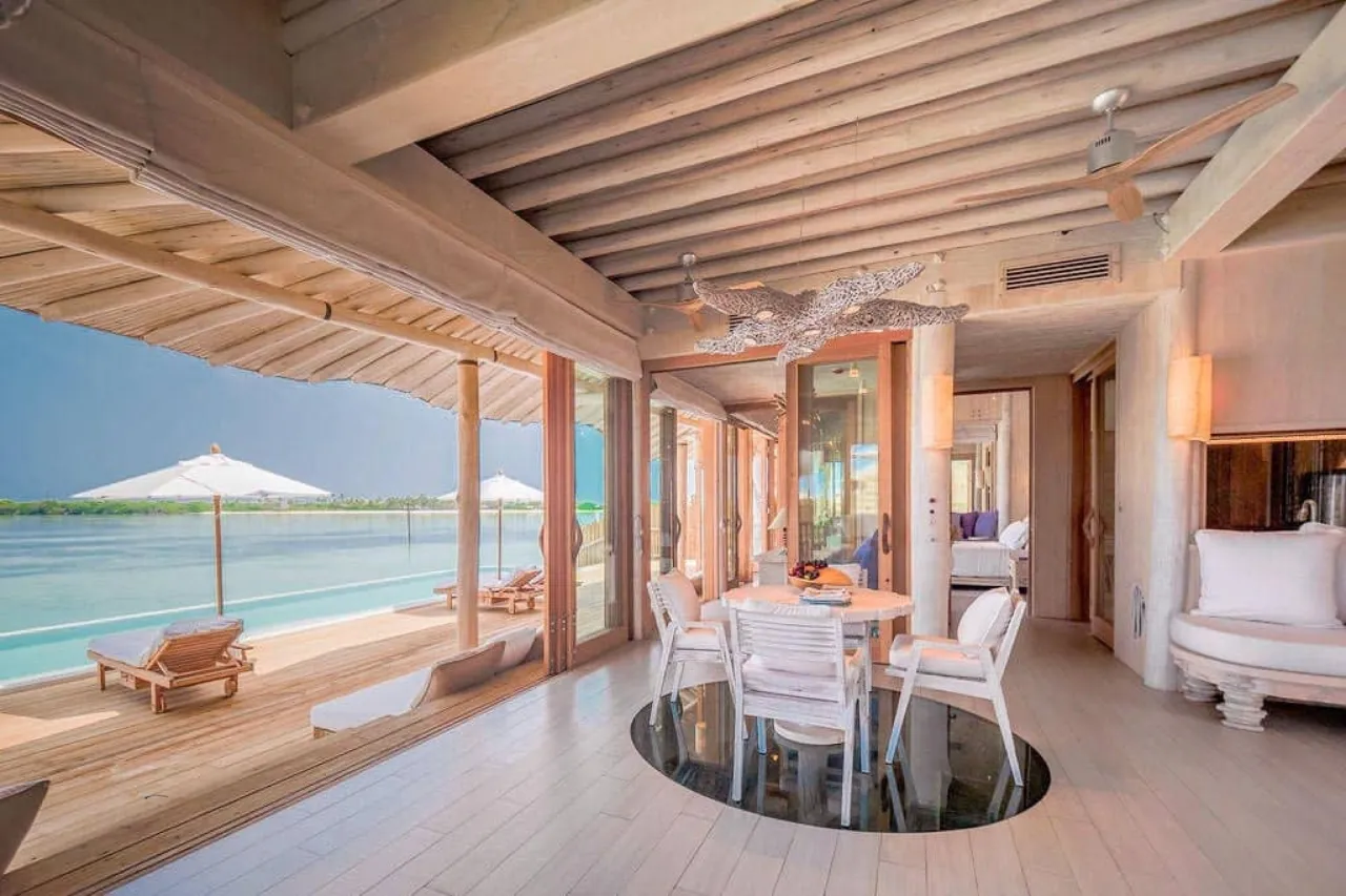 1-bedroom Maldives villa with slide, pool deck, and outdoor seating
