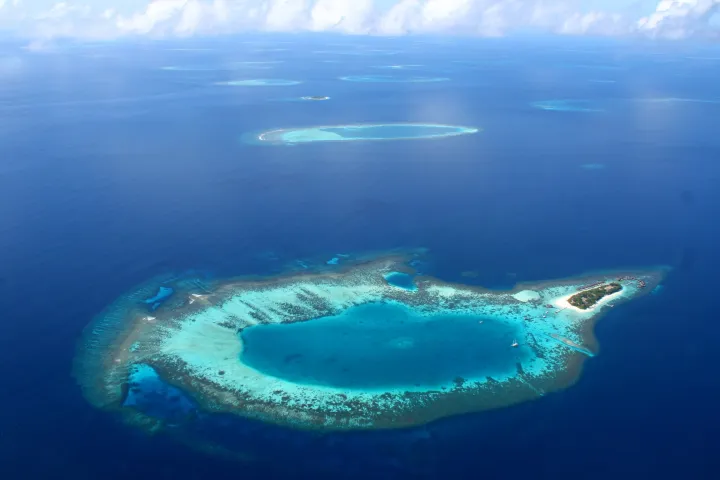 Aerial view of coral atolls showing the geography of the Maldives